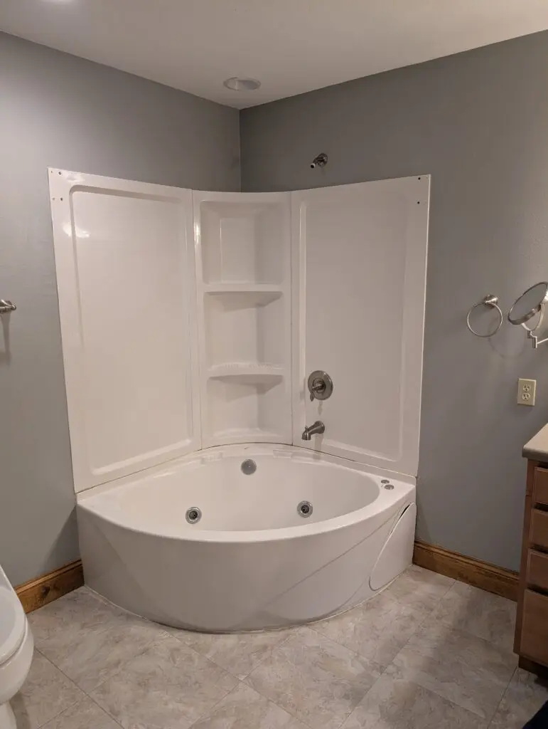 Old bathtub and shower with vinyl surround
